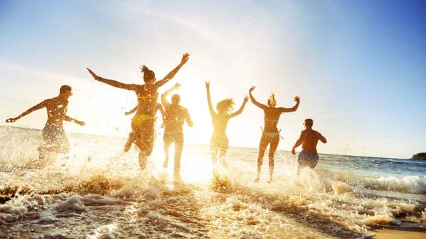 group having fun at the beach in the water