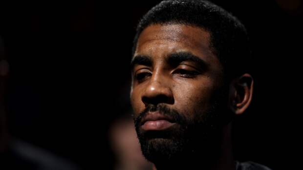 Kyrie Irving sits on the bench.