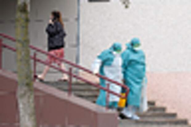 Medical employees wear protective suits as they leave a dormitory as a measure to fight against the coronavirus disease contagion (COVID-19) in Minsk, Belarus March 12