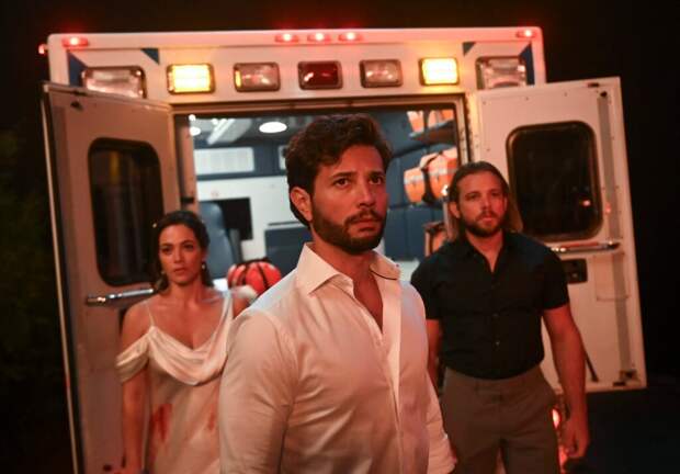 Gabriela, Diego, and Bode stand by an ambulance