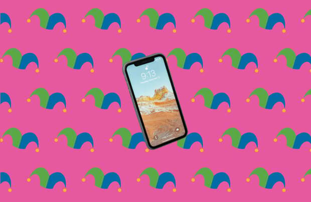 An iphone against a pink background