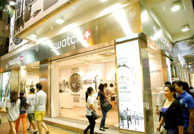 file-pedestrians-walk-past-a-swatch-store-in-hong-kong-china-12-october-2013-swatch-group-ag-p...jpg