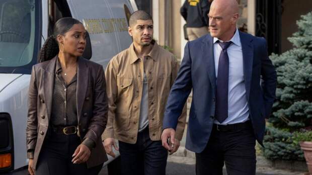 Stabler, Reyes, and Bell walking outside by a white van on Law & Order: Organized Crime Season 5 Episode 1