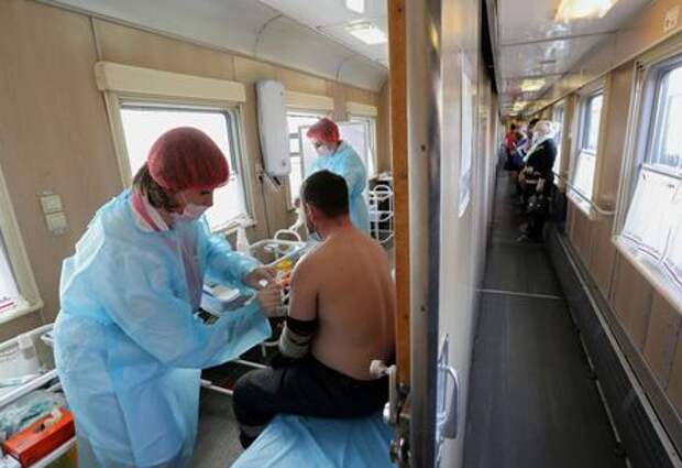 A man receives a dose of Sputnik V (Gam-COVID-Vac) vaccine against the coronavirus disease (COVID-19) in a carriage of the Academician Fyodor Uglov medical train, at a railway station in the town of Tulun in Irkutsk Region, Russia March 16, 2021. REUTERS/Evgeny Kozyrev TPX IMAGES OF THE DAY