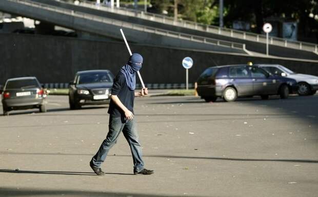 A protestor walks along a blocked street during an opposition rally in Tbilisi