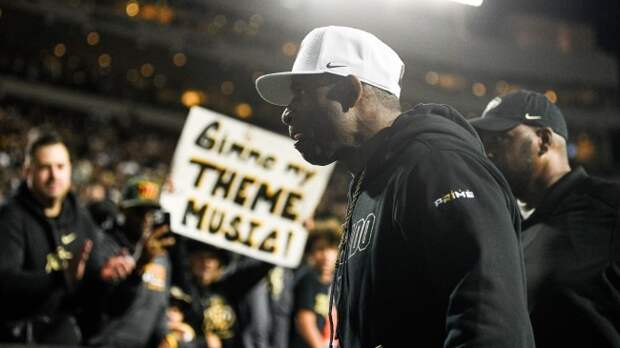 Deion Sanders walks off the field after Colorado's overtime win over Colorado State.