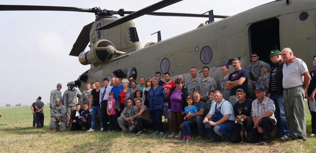 Residents of Gruta, in northern Poland, pose for a photo with U.S. troops and their Chinook helicopter on Tuesday.