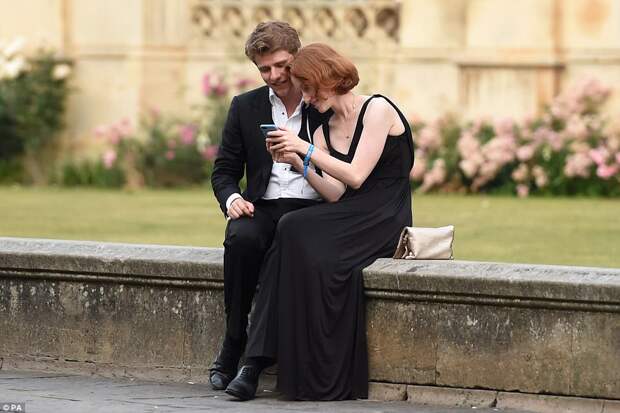 A couple look at snaps from the May Ball, which is steeped in tradition and last year celebrated its 150th installment