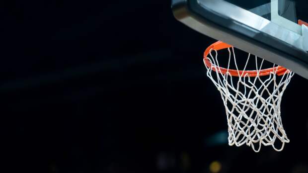 A view of a basketball hoop from the baseline.