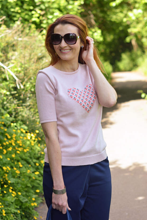 Pink motif sweater and loose navy pants