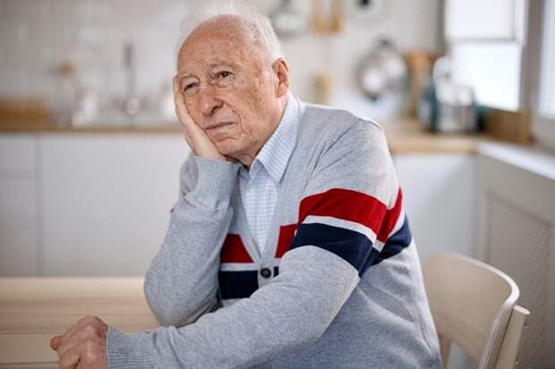 A person at a table resting their face in their hand.