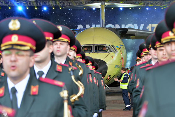 A military orchestra performs during the presentation of the new Antonov An-178 plane at the Antonov aircraft manufacturing plant in Kiev on April 16, 2015. The new Antonov cargo plane is designed to carry 18,000 kgs of payload and fly up to 12,200 meters. AFP PHOTO / GENYA SAVILOV