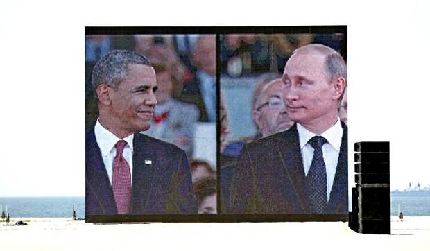 A huge video screen on Sword Beach shows U.S. President Barack Obama and Russian President Vladimir Putin as they arrive for the International 70th D-Day Commemoration Ceremony in Ouistreham