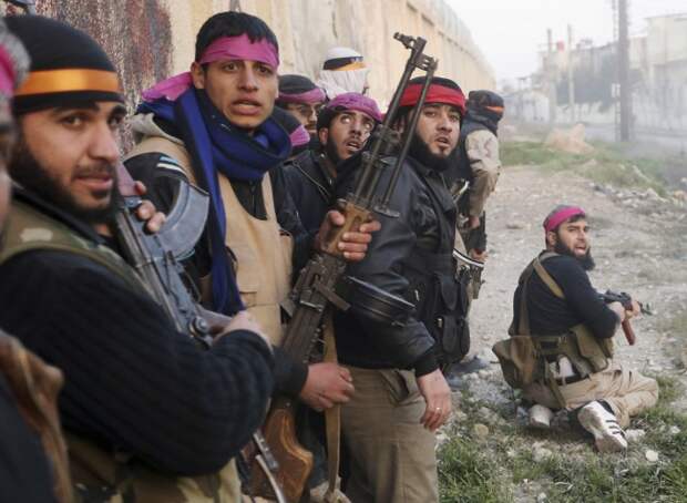 Free Syrian Army fighters take cover as they enter a Syrian Army base to take part in an attack in Damascus in this February 3, 2013 file photo.  The infantry skirmish for control of the barracks involved teams of fighters, their colourful headscarves at odds with grim faces and attempts at camouflage, stealing up to a two-metre perimeter wall that stretched for hundreds of metres around. They poured sustained rifle fire through gaps in the wall, tossed grenades over and did what they could to avoid incoming rounds.   REUTERS/Goran Tomasevic/Files (SYRIA - Tags: CIVIL UNREST POLITICS CONFLICT)  ATTENTION EDITORS PICTURE 17 OF 20 FOR PACKAGE 'BLOODY STALEMATE IN DAMASCUS' SEARCH 'GORAN STALEMATE' FOR ALL IMAGES