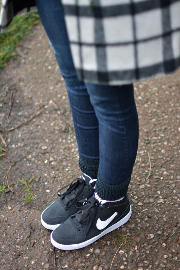 Black and white check coat with denim and Nike hi-tops