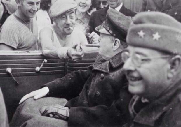 A Frenchman gives a light to Winston Churchill, 1944.