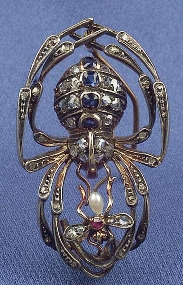 Sapphire, ruby, diamond, pearl, silver and gold brooch, depicting a spider which has caught a fly.