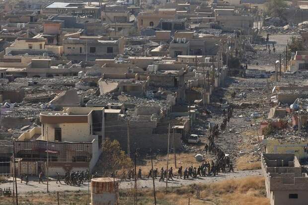 Members of the Kurdish peshmerga forces gather in the town of Sinjar