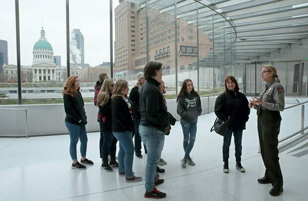 Park ranger Rhonda Schier, right, welcomes visitors to the Gateway Arch in St. Louis on Sunday, the first day it has been open since the federal government shutdown.