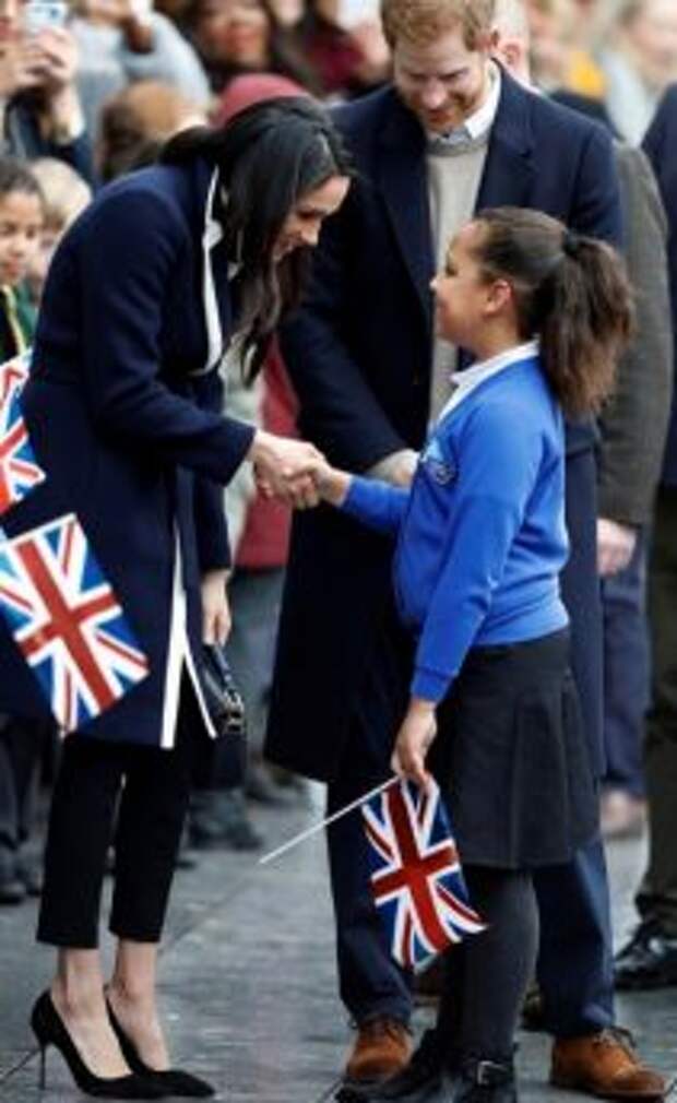 Meghan Markle talks to a local schoolgirl during a walkabout with Britain's Prince Harry during a visit to Birmingham, Britain, March 8, 2018. REUTERS/Phil Noble - RC1C2964AB20