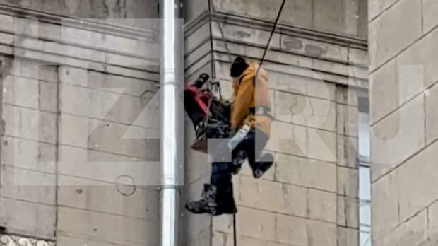 В Санкт-Петербурге дворник сорвался с крыши и повис на проводах