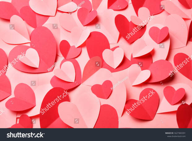 Bunch of cut out of pink and red paper hearts on pink background. Cute Valentines day, Womans day, love, romantic or wedding card, banner, invitation, sale, offer, ad background  for banner, congratulation, card, offer, flyer, advertising, invitation.