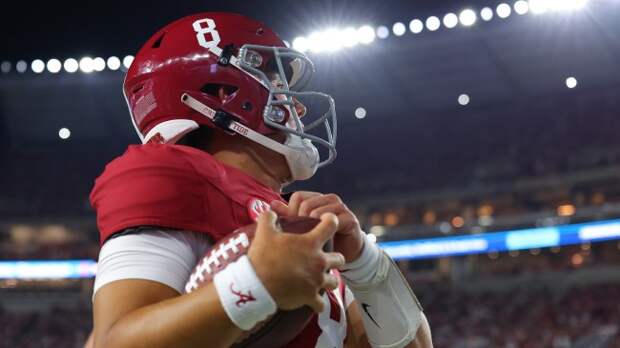 Tyler Buchner on the field before an Alabama football game.