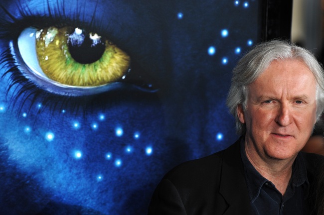 james cameron in front of an avatar poster