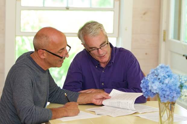 Two people reviewing documents together.