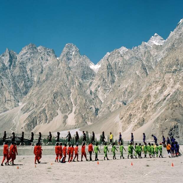 In Pakistan's Hunza Valley, all-girl soccer teams from surrounding villages walk onto the field for a tournament. This picture appeared in an online story called "The rising voices of women in Pakistan" in February 2019.