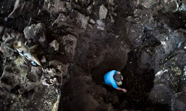 Paleoanthropologist Prof Lee Berger, who discovered the Australopithecus sediba, peers into the Cradle Of Humankind site in South Africa.